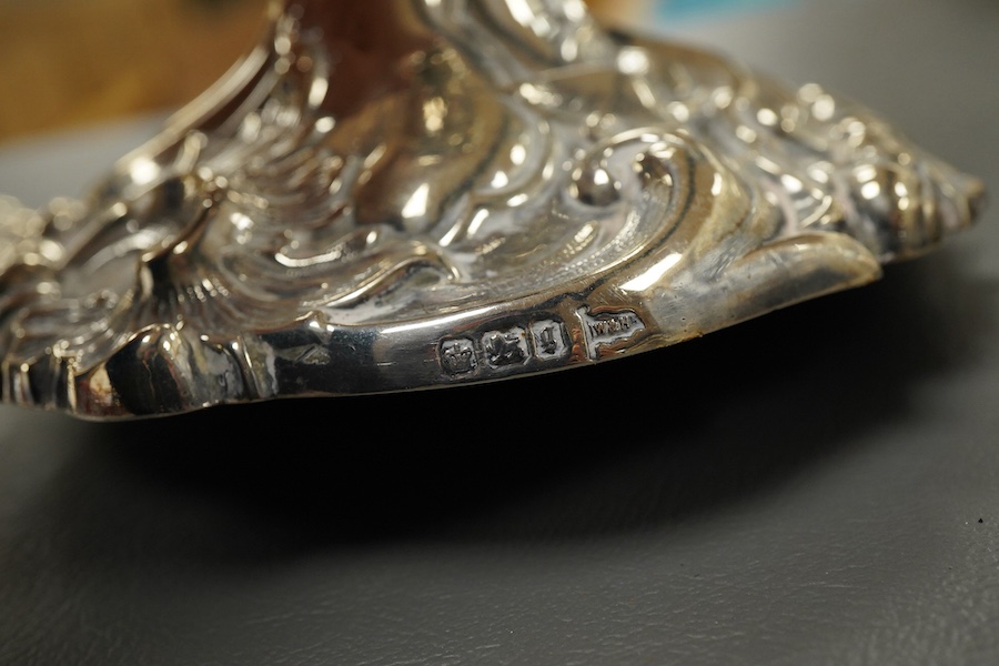 A pair of late Victorian silver candlesticks, with foliate decoration, by Walker & Hall, Sheffield, 1899, height 23cm, weighted.